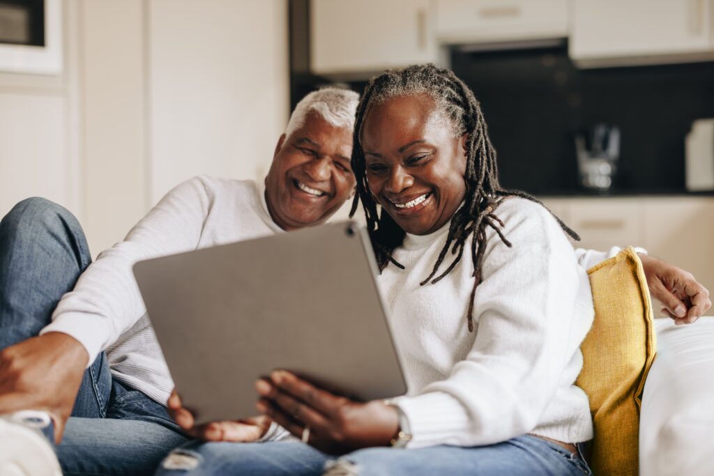 senior African American couple looking at tablet